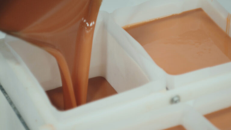 Soap mixture being poured into a soap molder