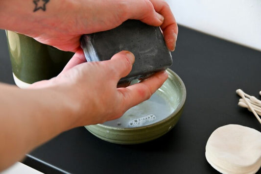 Washing hands using charcoal soap bar