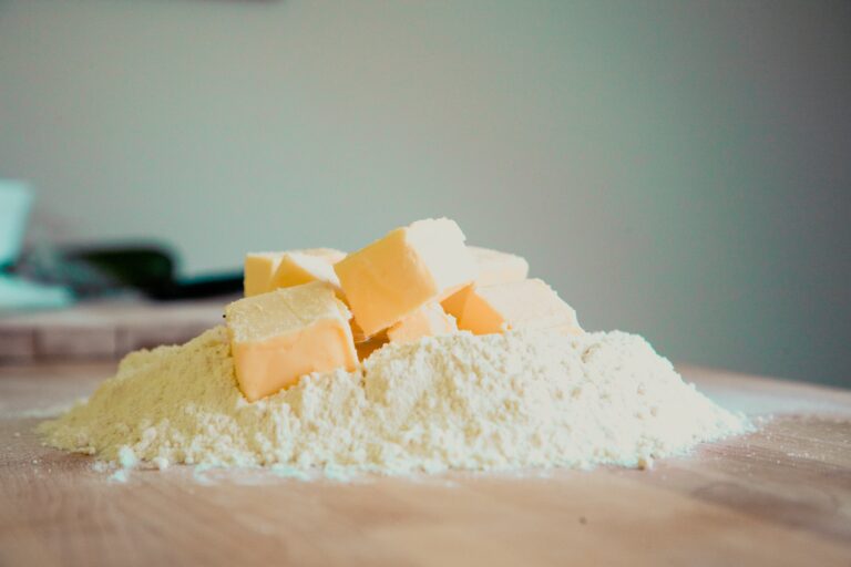 Pieces of cubed butter with flour in a chopping board