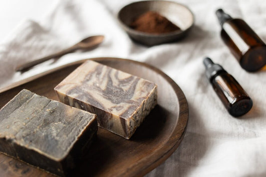 Two natural soap bars and two essential oils