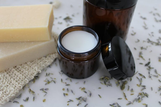 Organic body butter in amber jars with natural soap bars and lavender